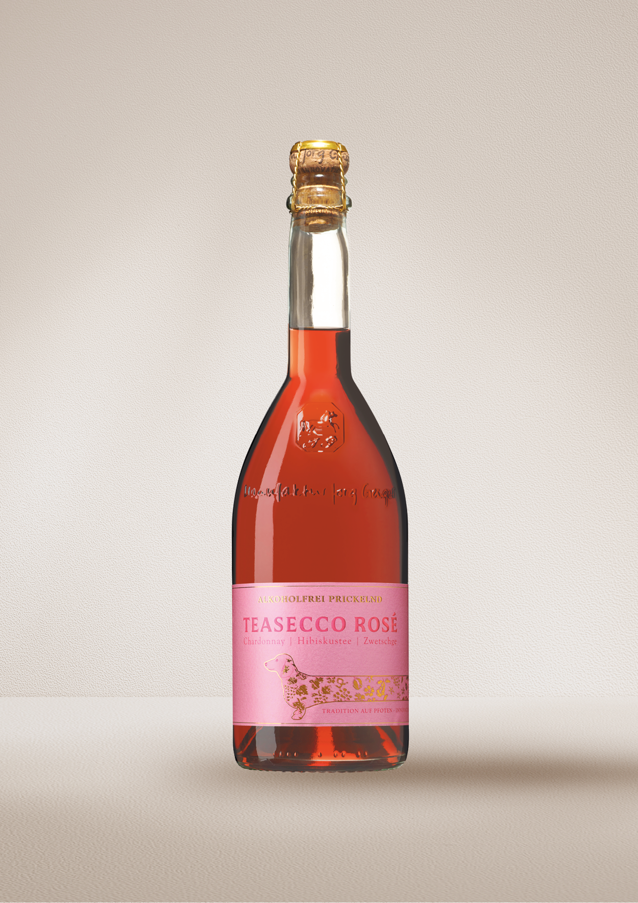 Bottle of "TEASECCO Rosé". Dealcoholized wine on a beige background.