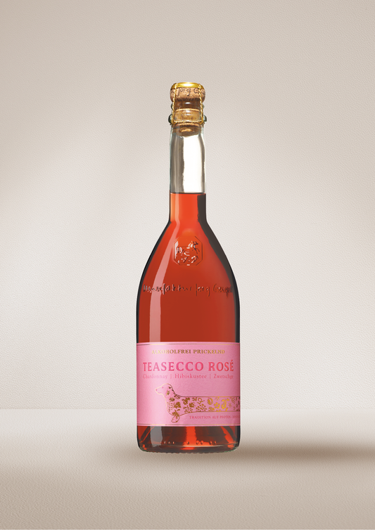 Bottle of "TEASECCO Rosé".  Dealcoholized wine on a beige background.
