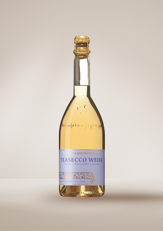 Bottle of "TEASECCO Weiss".  Dealcoholized wine on a beige background.